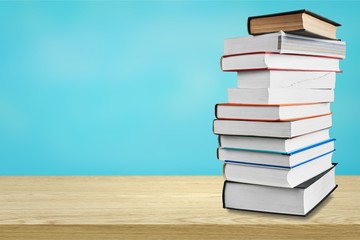 Colorful books collection on background.