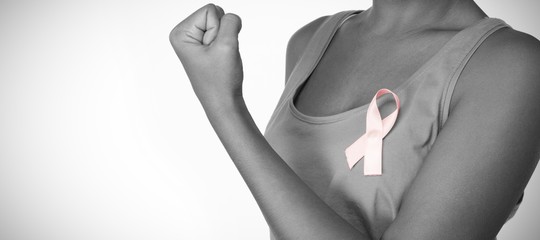 Woman shows pink ribbon for breast cancer awareness