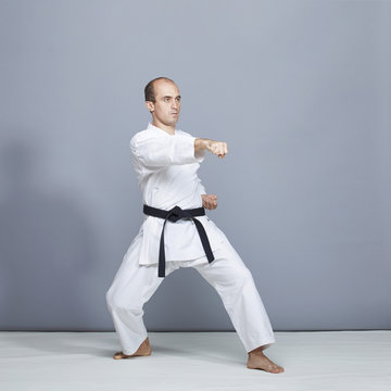 With a black belt, the athlete performs formal karate exercises