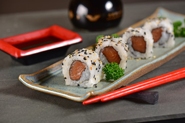 Salmon nigiri sushi plate on black background © marcelokrelling