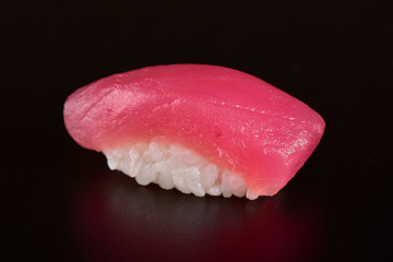 Tuna nigiri sushi isolated on black background