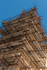 Construction scafold to restore church limestone.  Malta. Vertical.