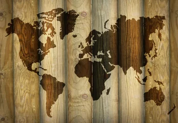Poster Shadow of a world map projecting on wooden planks as a background © vali_111