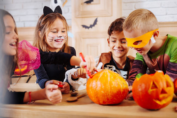 Fototapeta premium Appealing cat girl. Cute appealing little girl wearing cat costume laughing out loud playing with friends