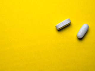 pills on a yellow background