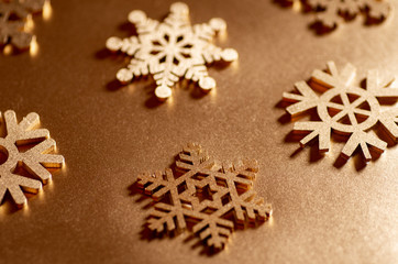 Fototapeta na wymiar Golden snowflakes for decoration. Christmas decorative snowflakes. Wooden snowflakes.