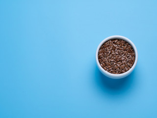 flax in white cup on a blue background