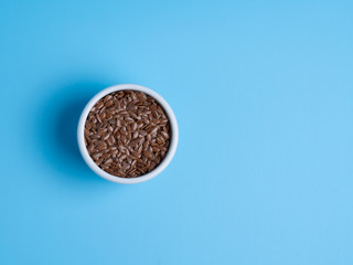 flax in white cup on a blue background