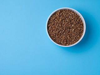 buckwheat in white cup on a blue background