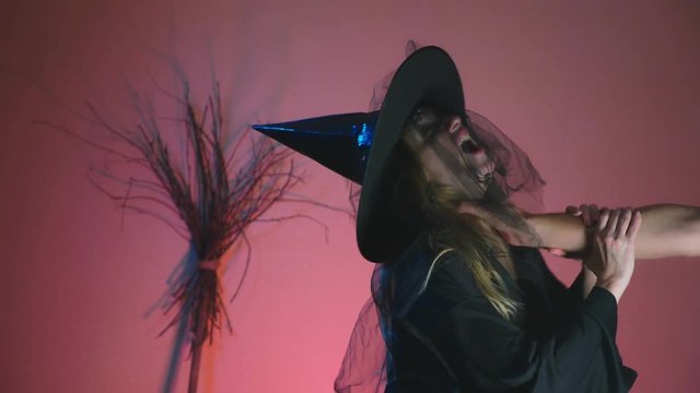 4k, slow-motion, halloween. The hand strangles the witch.