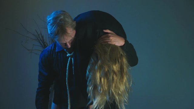The zombie carries his victim on his shoulder. 4k, slow motion, Halloween concept