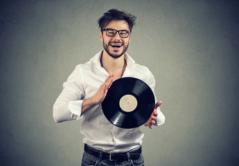 Happy man with retro vinyl disk