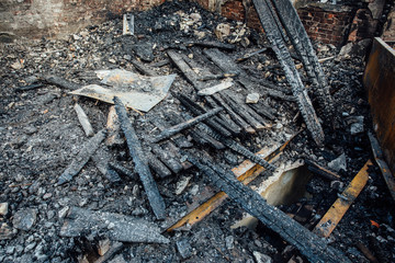 Burnt wooden planks, ruined floor of burned building