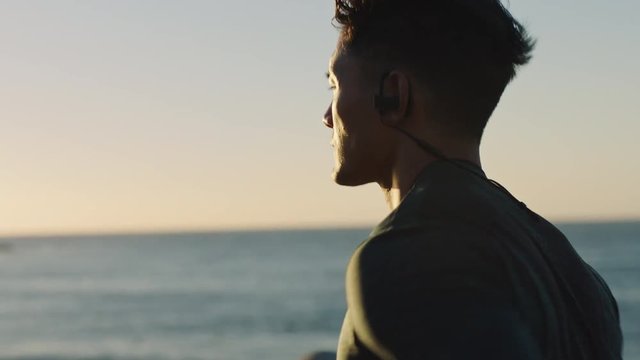 young athlete man running muscular runner exercising cardio jogging intense focus on calm ocean seaside at sunset close up