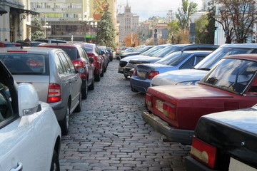 View at parking in ancient historical area in Kiev city. View of a car parking in a full parking lot.