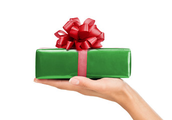 Close up of female hand holding, giving gift box isolated on whie background
