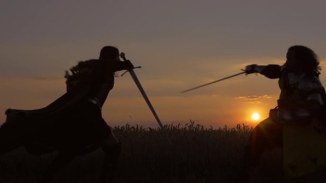 Fight at sunset. Epic cinematic look. Slow motion.