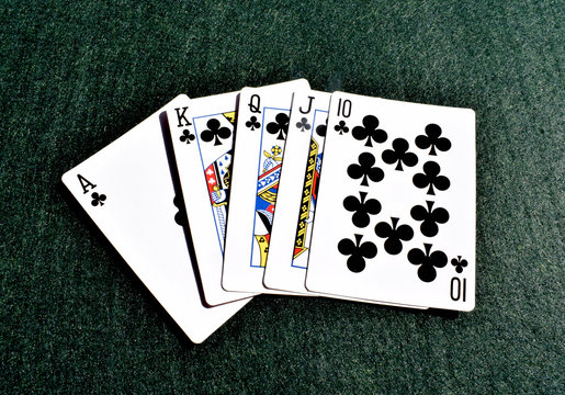 Royal Flush in pocker cards on a green background
