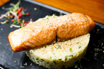Grilled salmon with liver foie gras, couscous and cucumber on white rice