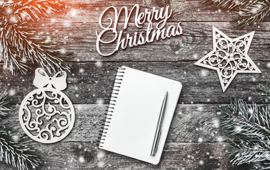 Winter composition, on old wood background. The space list for a Christmas message. Snow effect and...
