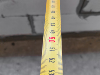 Measure tape, close up / Metal measure tape of yellow color, close up