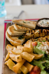 Greek gyros and souvlaki plate with pita bread and tzatziki