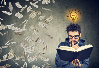 student reading a book has a bright idea how to earn money