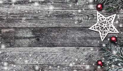 Wooden background. Merry Christmas inscription, text space, fir branches and gifts. Top view. Elements, balls and winter gifts. Snow effect