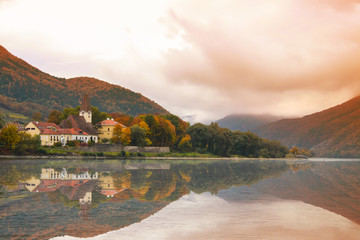 Fototapeta premium Quaint small town on the shore of the Danube River in Austria in the Fall