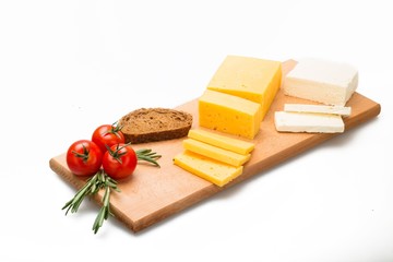 Cheeses, Tomatoes and Bread on the Wooden Platter