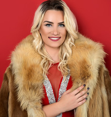 Young blonde woman wearing fur coat