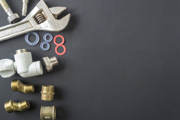 Tools for repair of water supply systems on a black background.