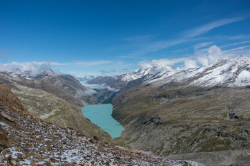 Fototapeta na wymiar View to Stausee lake near Saas Fee in the southern Swiss Alps from Monte Moro pass, Italy