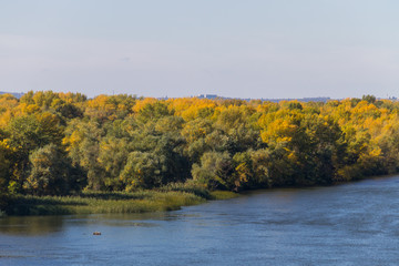 Colorful autumn trees on the riverfront.