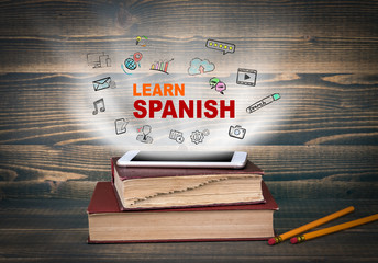 learn Spanish, education and business background. Concept cloud coming from screen of the phone,...