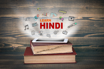 learn Hindi, education and business background. Concept cloud coming from screen of the phone,...