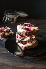 Chocolate cheesecake layered with brownie and dark cherrie. Chocolate cherrie cake. Pieces of chocolate cake. Winter dessert. Traditional american cuisine. Still life of food. Dark food photo.