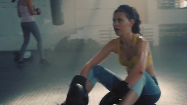beautiful woman resting kickboxer exhausted after boxing exercise workout strong female athlete breathing tired in gym enjoying fitness lifestyle