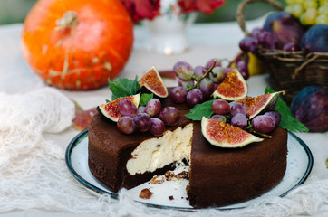 Autumn chocolate cake decorated with figs and grapes