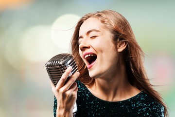 Young female singer with microphone