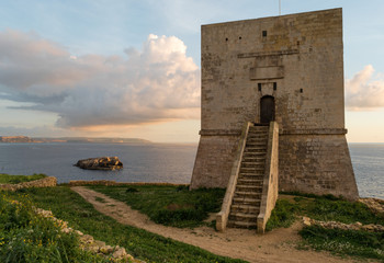 Mgarr Ix-Xini Bay Tower Gozo. Malta. Horizontal at sunset