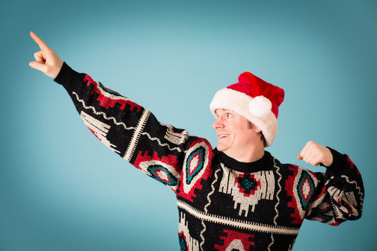 Happy Christmas Guy Posing in Ugly Sweater and Santa Hat