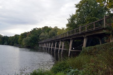 Fototapeta na wymiar Old stone bridge in the water - luna park