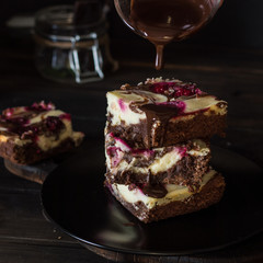 Chocolate cheesecake layered with brownie and dark cherrie. Chocolate cherrie cake. Pieces of chocolate cake. Winter dessert. Traditional american cuisine. Still life of food. Dark food photo.