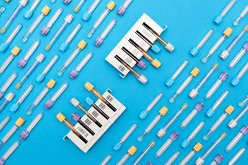 Blood samples in a rack. medicine test tubes blood for blue background. Flat lay, top view,...