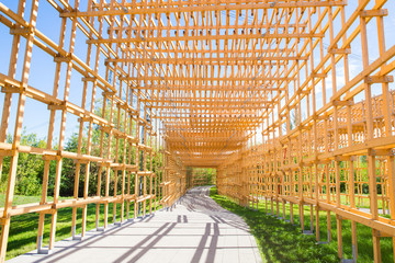 Yellow wooden arch on the road in park