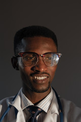 Fototapeta premium Handsome guy doctor in white lab coat with stethoscope on white background