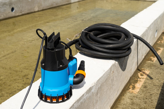 Submersible pump dewater construction site, pumping flood water sing deep well.