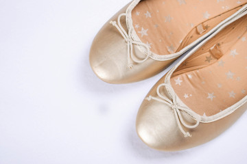 Kids shoes of gold colour.Moccasins for little princess