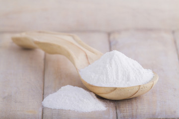 baking soda with wooden spoon on the table